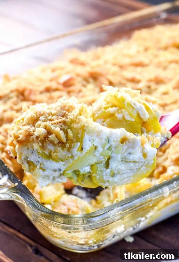 Creamy Southern Squash Casserole with yellow squash, sour cream, cheddar, and a cracker topping.