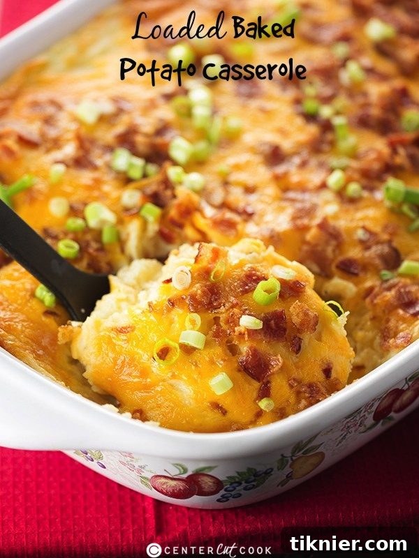 Hearty Loaded Baked Potato Casserole with bacon, cheddar cheese, and green onions, serving a crowd.