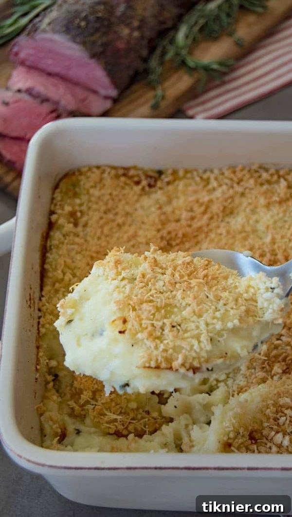 Creamy Rosemary Mashed Potato Casserole with cheese, topped with breadcrumbs and Parmesan.