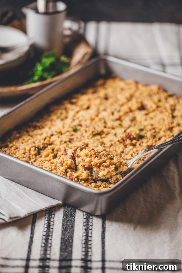 Savory Homemade Cornbread Dressing with fresh herbs and Italian sausage, a Southern holiday staple.