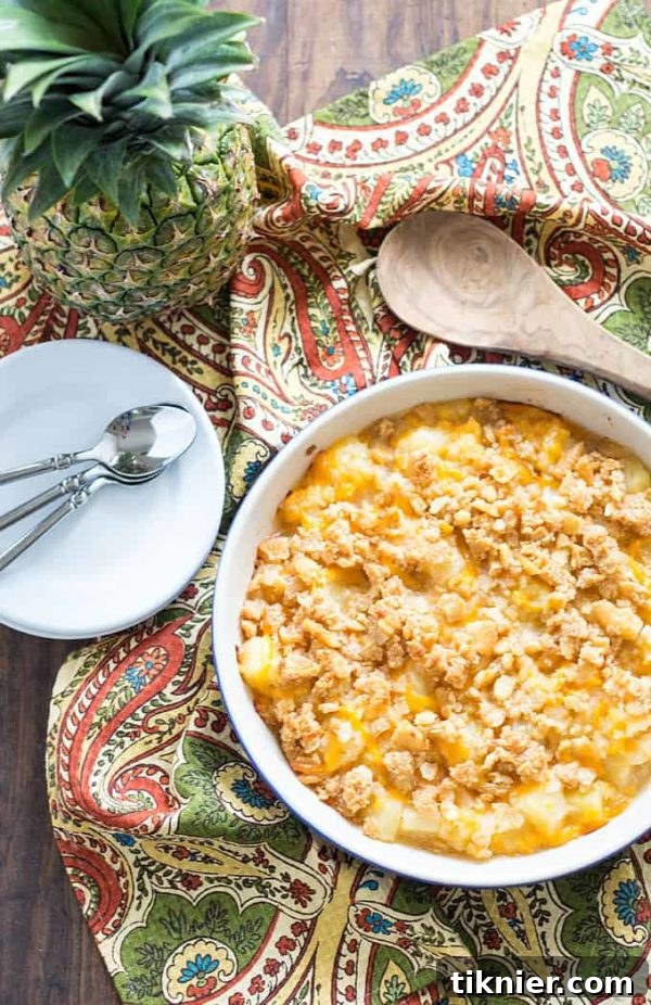 Unique Pineapple Casserole with sharp cheddar cheese and a buttery topping, a sweet and savory surprise.