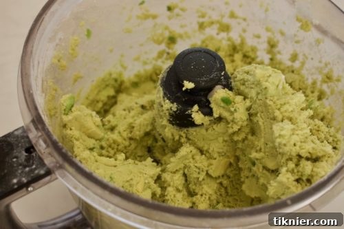 Grain-free chive and sage biscuit dough forming in a food processor