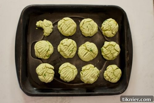 Forming grain-free biscuits with wet hands on a baking sheet