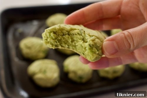Freshly baked grain-free herbed chive and sage biscuits on a baking sheet