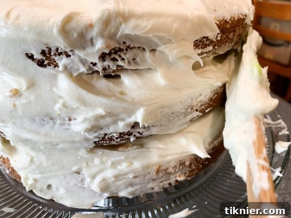 Assembling a beautiful three-layer Hummingbird Cake with frosting.