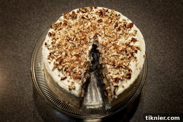 A close-up slice of moist Hummingbird Cake, showing layers and frosting.