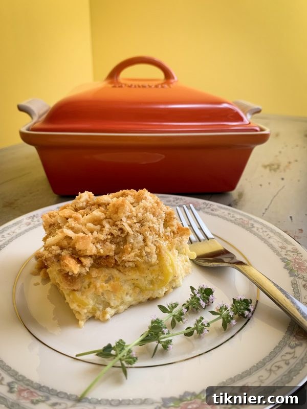 Squash Casserole in a Le Creuset Heritage Covered Square Casserole dish