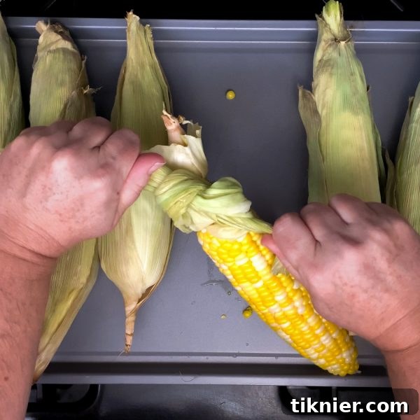Pull corn husks tightly to form a secure handle