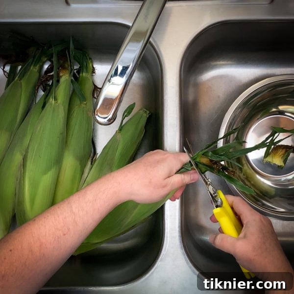 Trim the corn silks and husks before soaking