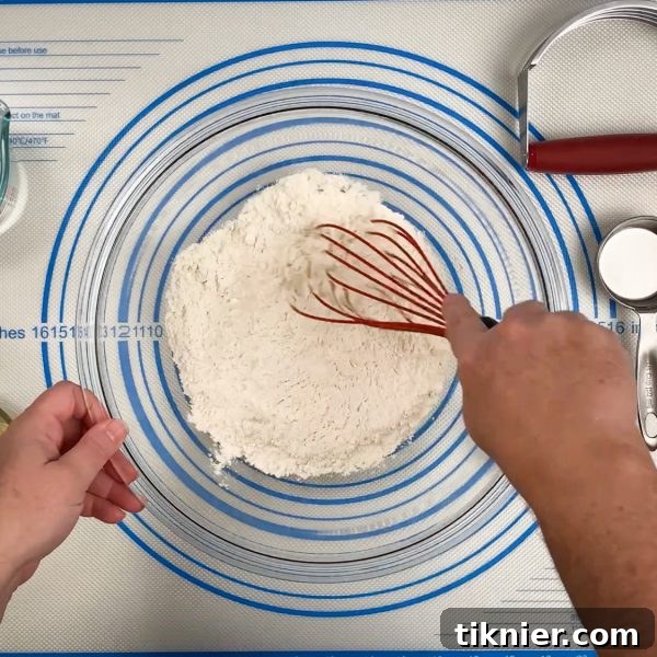 Irresistible Chess Pie 11 whisking dry ingredients for pie crust, with butter pats visible