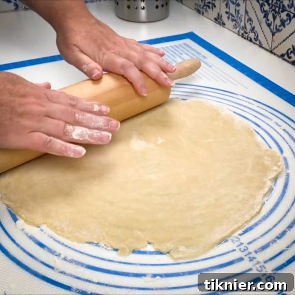 Irresistible Chess Pie 15 rolling out pie dough into a large circle on a pastry mat