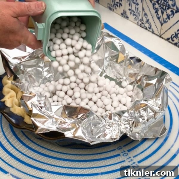 Irresistible Chess Pie 18 ceramic pie weights filling a foil-lined pie crust