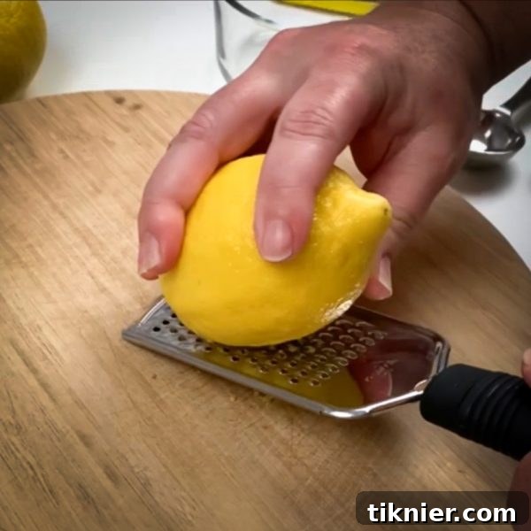 Irresistible Chess Pie 20 a microplane zesting a lemon over a bowl