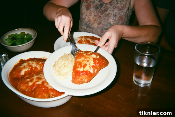 Chicken Parmesan served with spaghetti and fresh basil, ready for a family meal