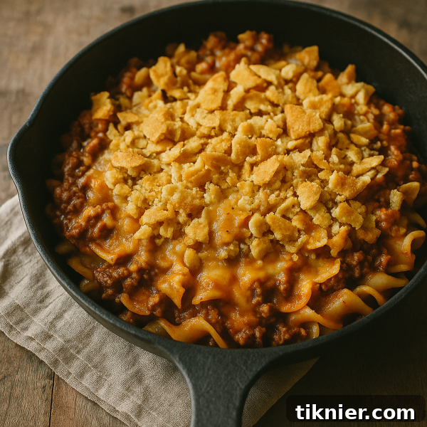A close-up shot of the Poor Man's Husband Casserole, showcasing its creamy interior and golden, crunchy cracker topping.
