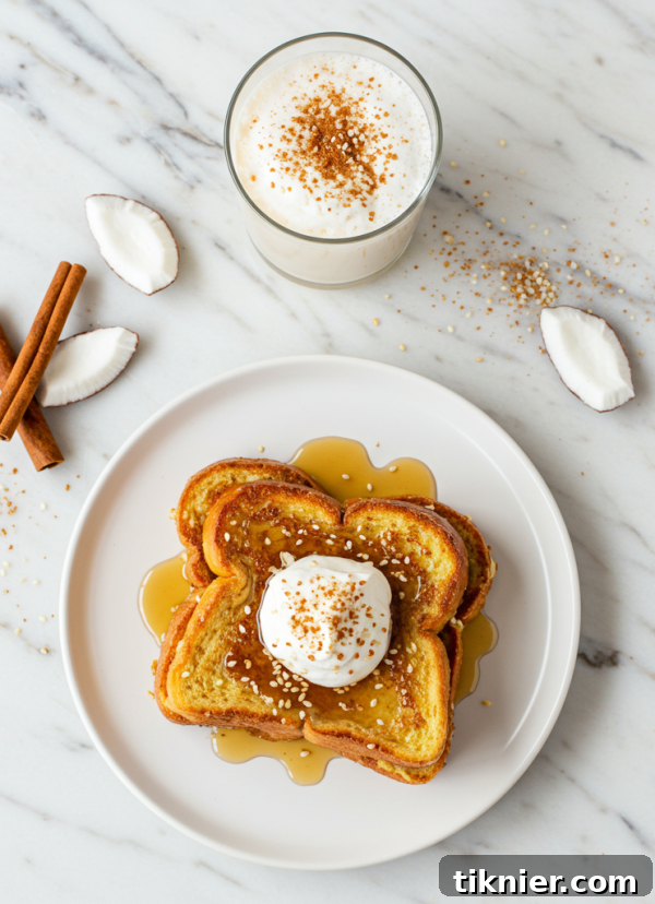 Delicious French toast without milk made with coconut cream and topped with toasted sesame seeds and fresh berries.