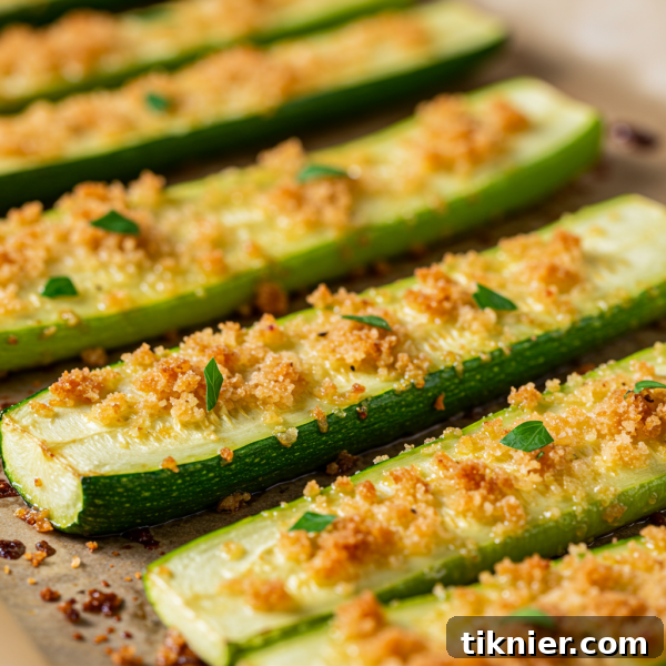 Quick and Tasty Roasted Zucchini Perfection 2 Delicious roasted zucchini slices on a baking sheet, ready to be served.