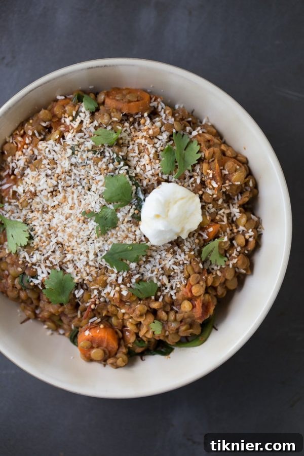 A vibrant bowl of vegetarian spiced lentils with toasted coconut, a delicious meatless dinner