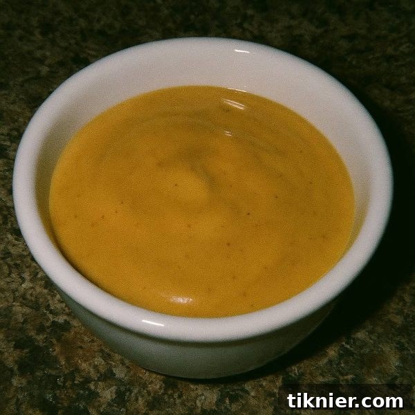 Delicious homemade Chick-fil-A sauce in a bowl with waffle fries