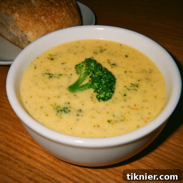 Warm bowl of creamy Panera Broccoli Cheddar Soup with a spoon