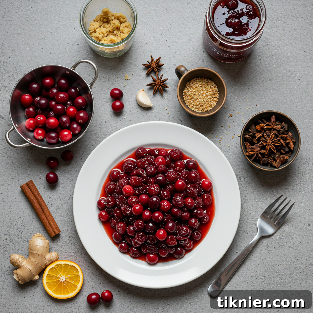 Close-up of a bowl of homemade cranberry chutney with whole cranberries and pieces of candied ginger visible.