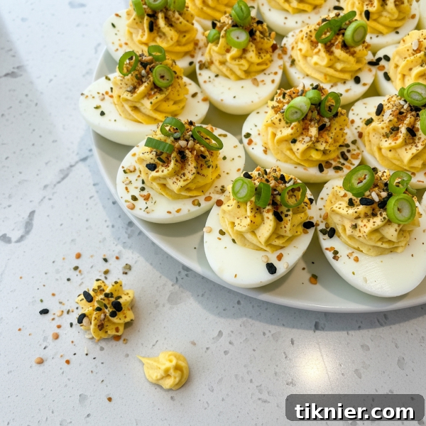 Close-up of Miso Deviled Eggs with Furikake and scallion garnish.