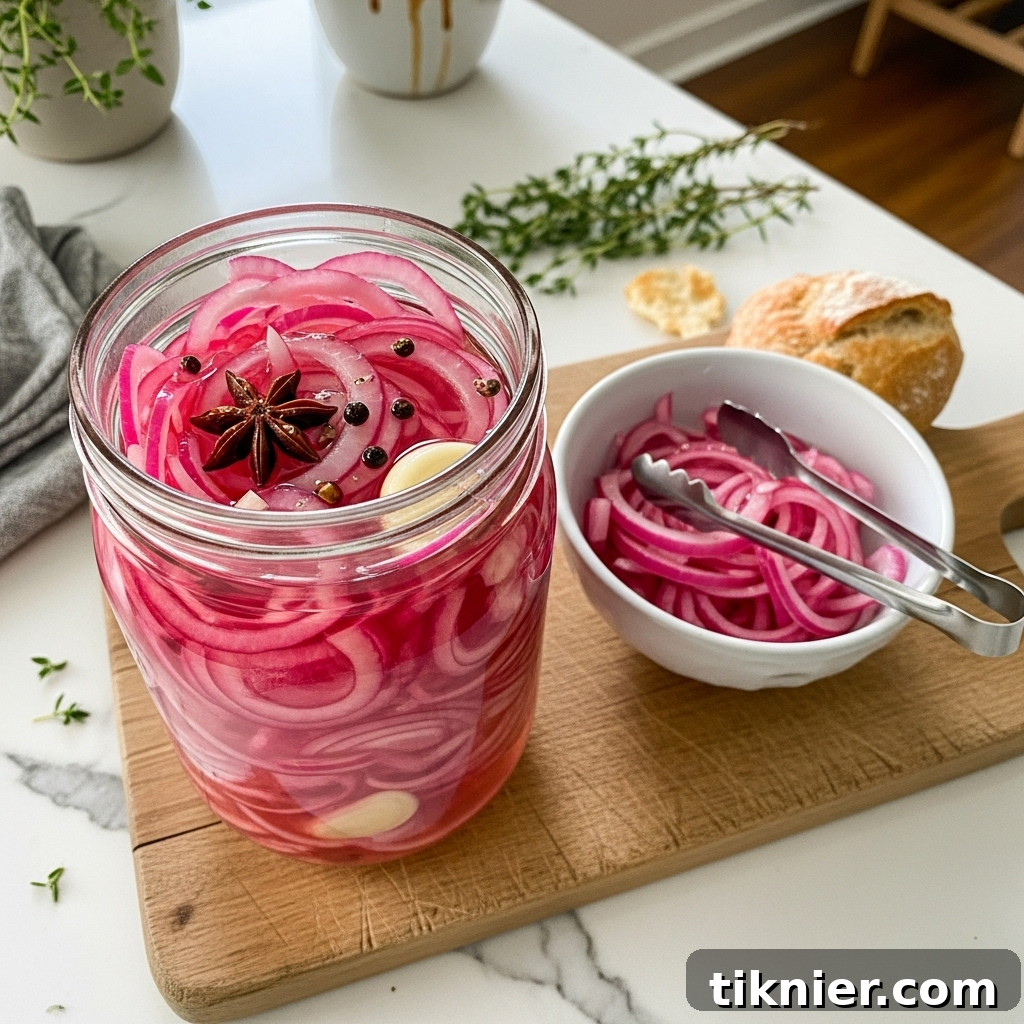 A glass jar filled with vibrant pink star anise pickled red onions, ready to be served, with a single star anise pod visible.
