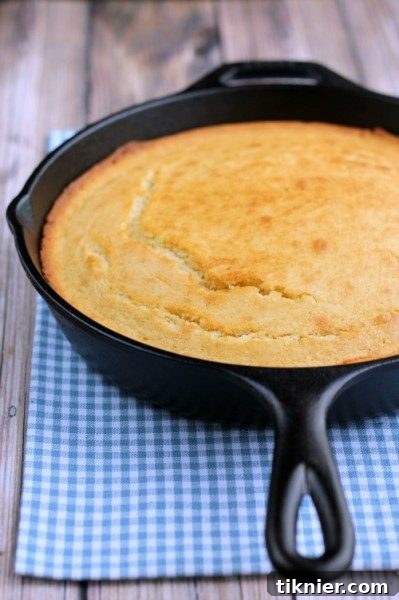 A slice of golden cornbread, a classic American bread perfect for Thanksgiving.
