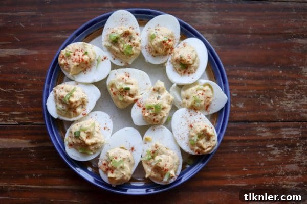 A platter of creamy, tangy miso deviled eggs, garnished for a festive look.