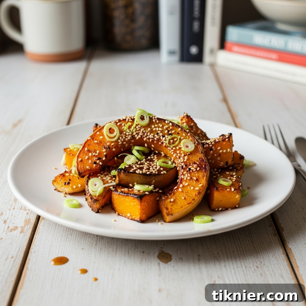Platter of Miso Hot Honey Roasted Butternut Squash garnished with sesame seeds and scallions.