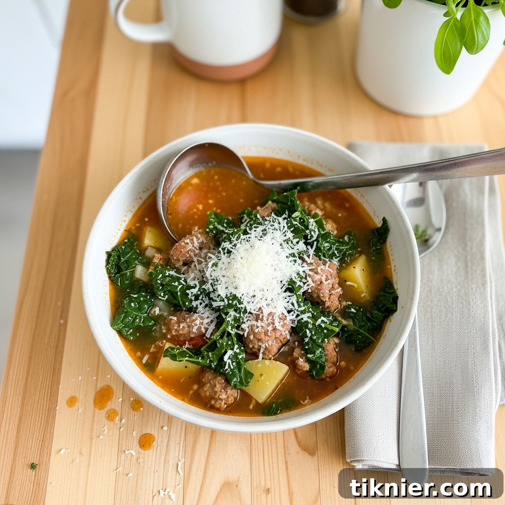 The Ultimate Hearty Sausage and Kale Soup 3 A close-up shot of a pot filled with creamy sausage and kale soup, ready to be served, highlighting its rich texture and vibrant ingredients.