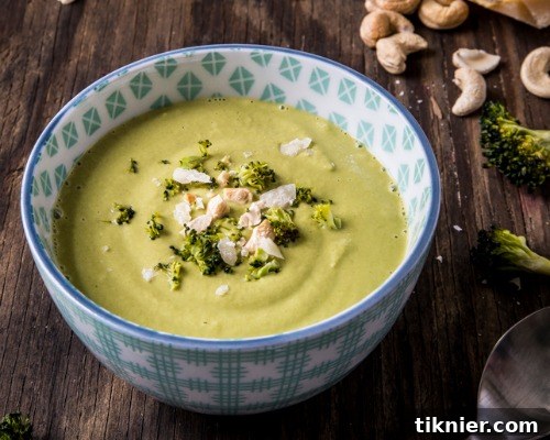 A vibrant bowl of healthy green soup, garnished for a fresh look.